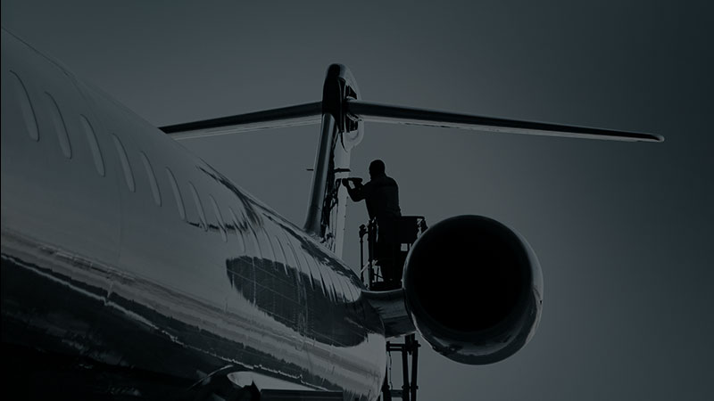 Ingénieur de MHIRJ faisant de la maintenance sous un avion